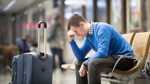 Man stressed waiting for luggage 