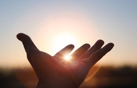Hand oustretched to sun