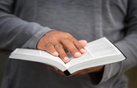 Man with hand on Bible
